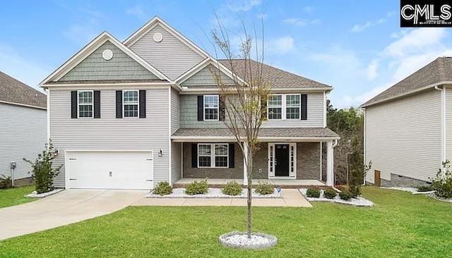 view of front of house with a garage, a porch, and a front lawn