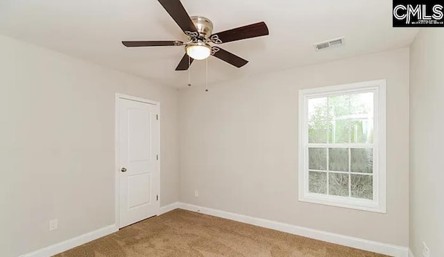 empty room featuring ceiling fan and light carpet