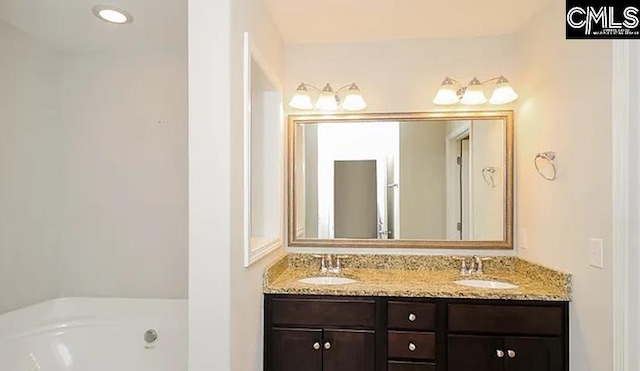 bathroom with vanity and a washtub