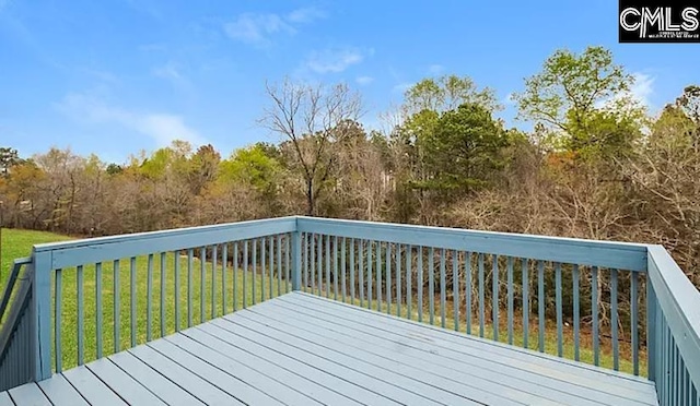 wooden terrace featuring a yard