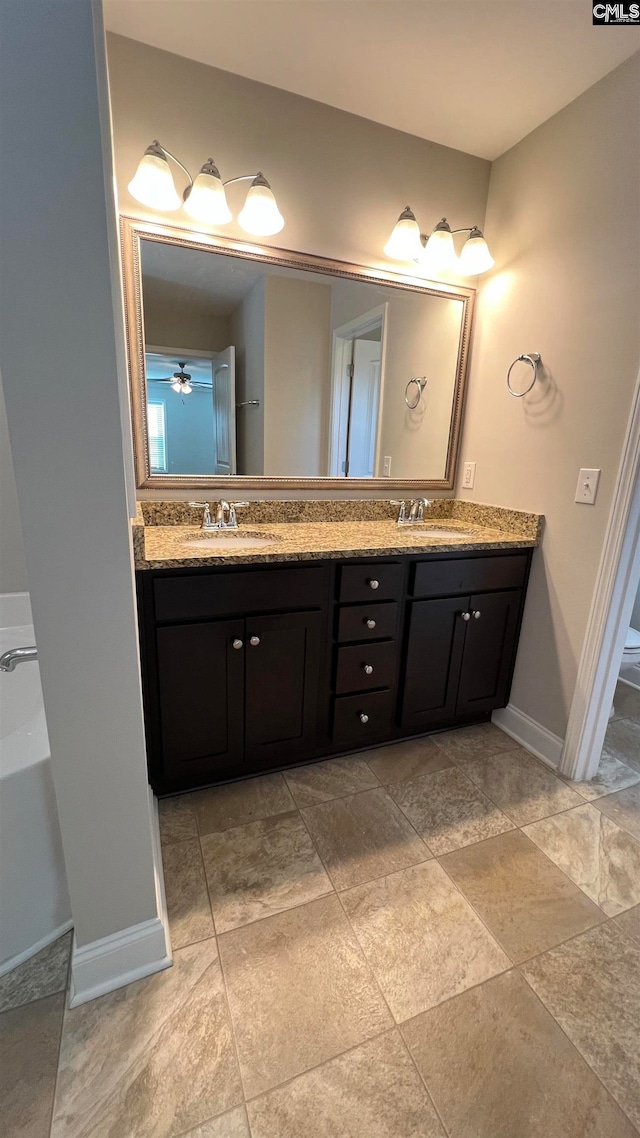 bathroom featuring ceiling fan and vanity