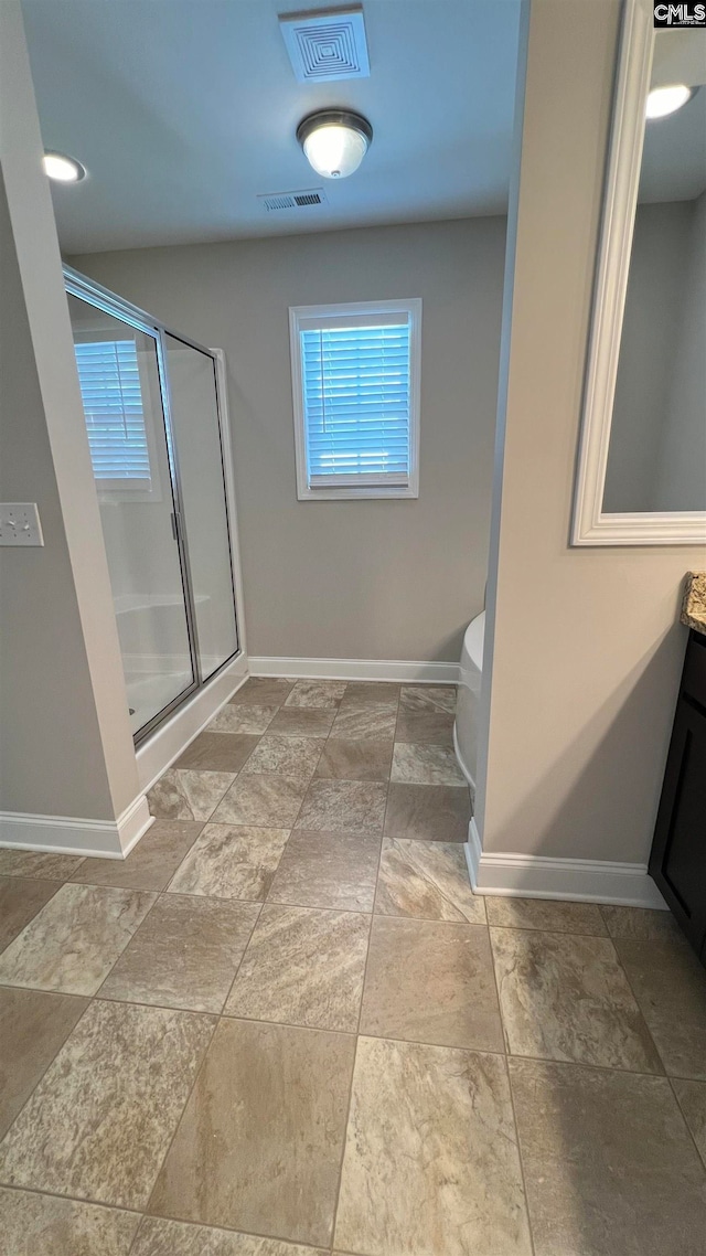 bathroom with an enclosed shower, toilet, and vanity