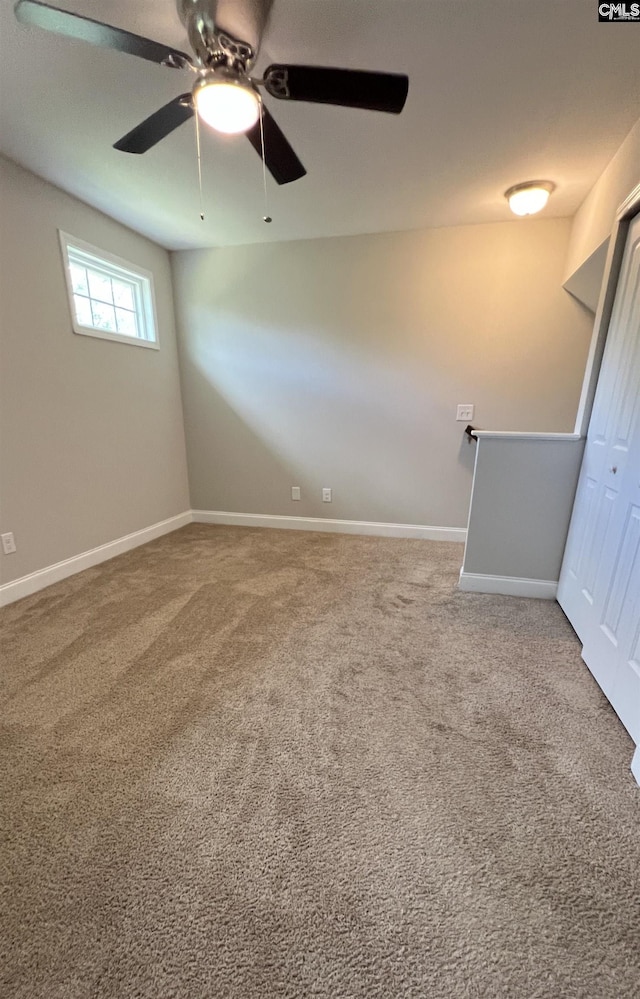 carpeted empty room with ceiling fan