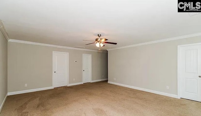 empty room with crown molding, ceiling fan, and carpet floors