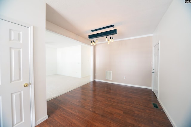 spare room with dark wood-type flooring