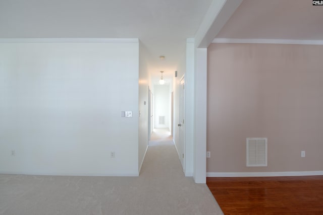 hallway with crown molding and wood-type flooring