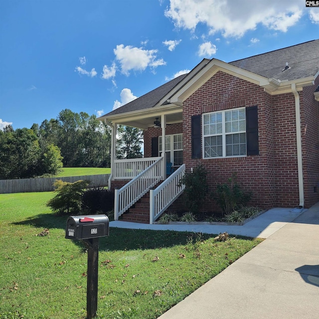 view of front of property with covered porch and a front lawn