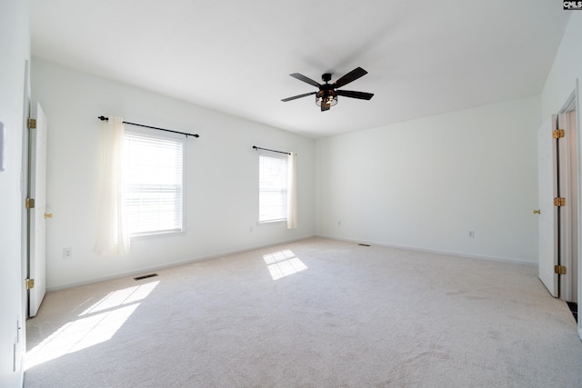 empty room featuring light colored carpet and ceiling fan