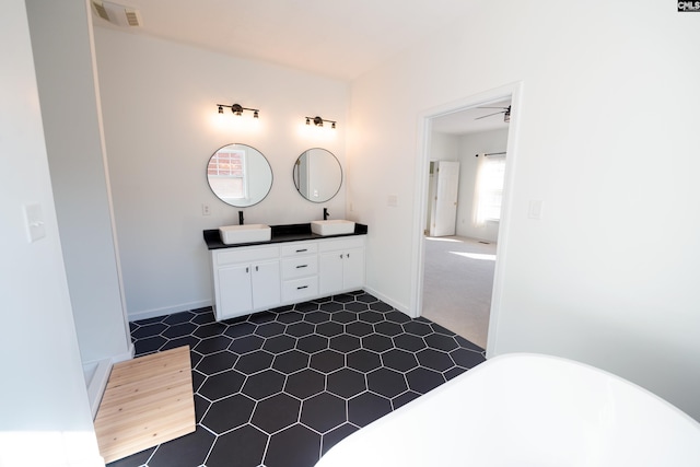 bathroom featuring vanity, a bath, and ceiling fan