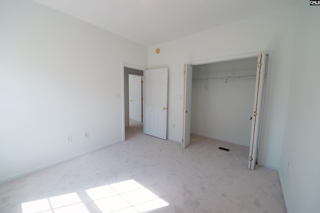 unfurnished bedroom featuring light carpet