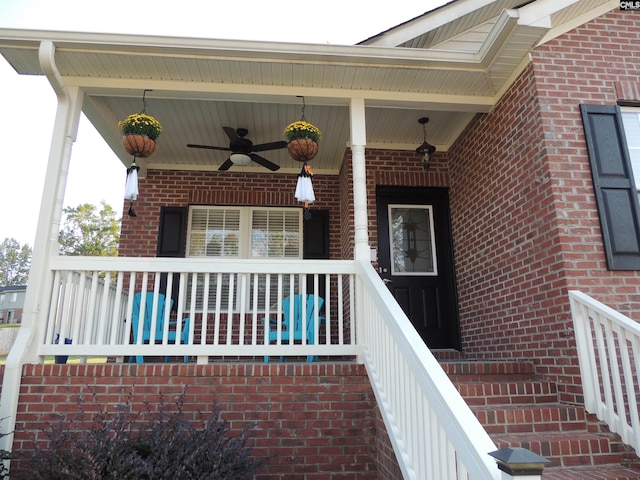 view of exterior entry featuring a porch and ceiling fan