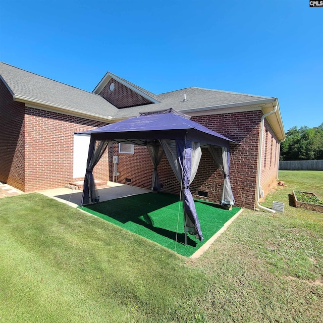 back of property featuring a yard and a patio area