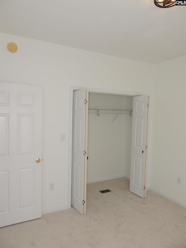 unfurnished bedroom with light colored carpet