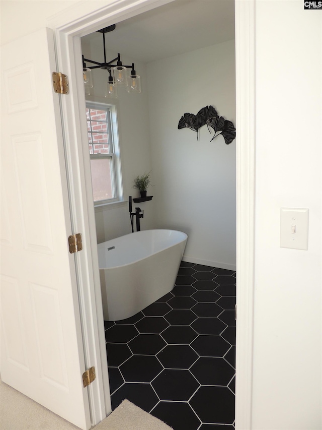 bathroom featuring tile patterned floors and a bathtub