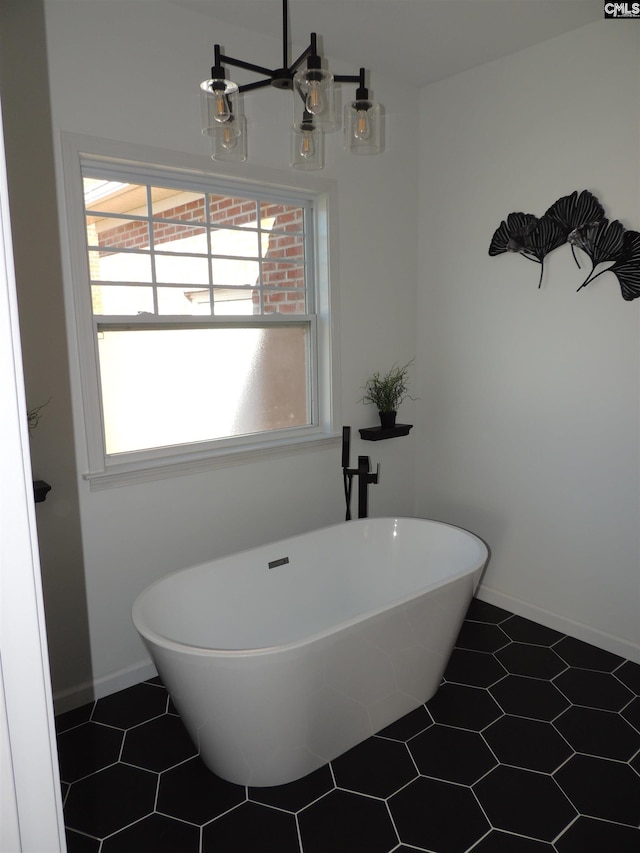 bathroom with a washtub and tile patterned flooring