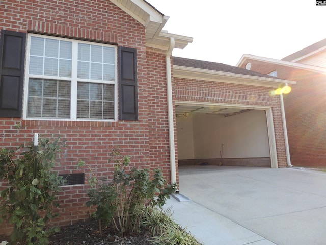 view of side of home featuring a garage