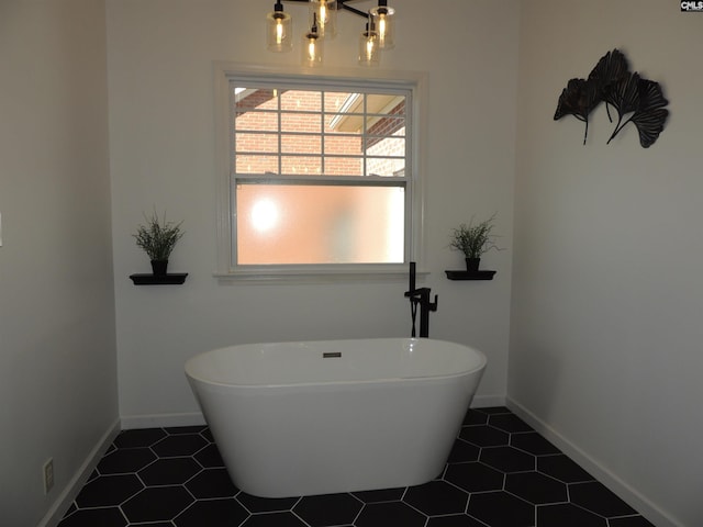 bathroom with a bathtub and tile patterned floors