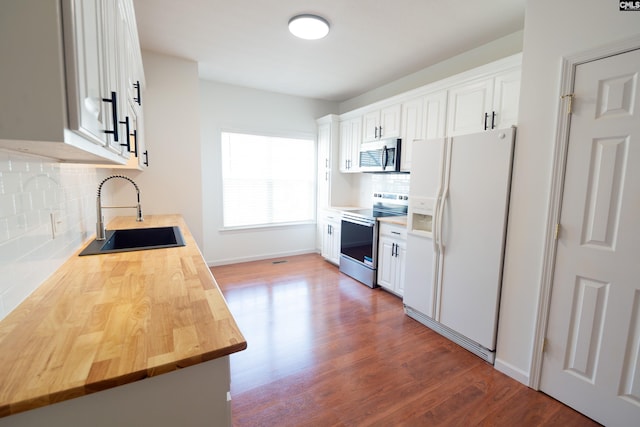 kitchen featuring dark wood-type flooring, stainless steel appliances, backsplash, sink, and white cabinets