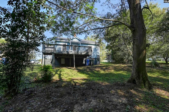 back of house with a lawn and a deck