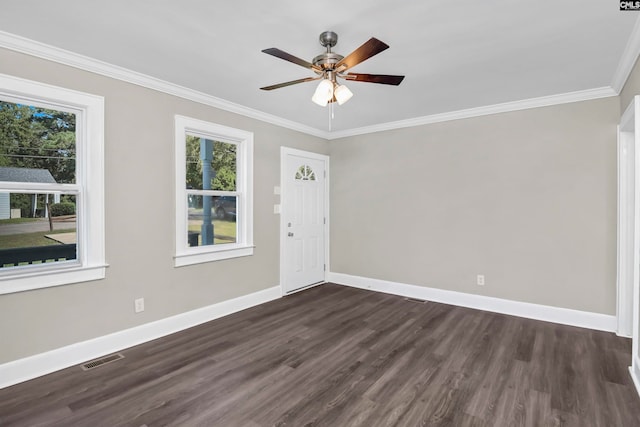 unfurnished room with ornamental molding, ceiling fan, and dark wood-type flooring