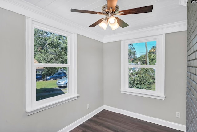 spare room with ceiling fan, plenty of natural light, ornamental molding, and dark hardwood / wood-style flooring