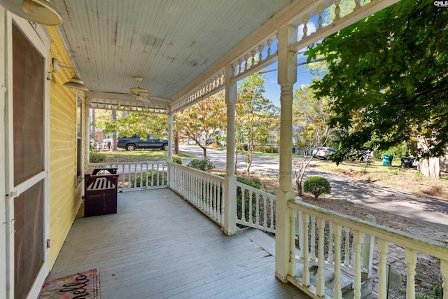 wooden deck featuring ceiling fan and covered porch