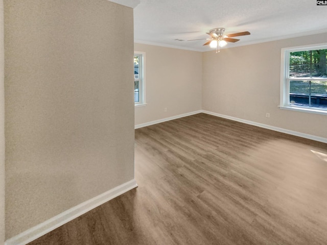 empty room with ceiling fan, ornamental molding, and hardwood / wood-style floors