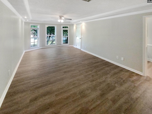 empty room with a raised ceiling, a textured ceiling, and ceiling fan