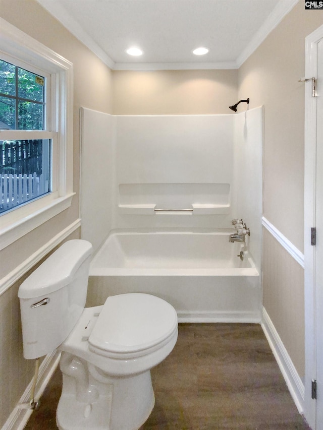 bathroom with hardwood / wood-style floors, bathtub / shower combination, crown molding, and toilet