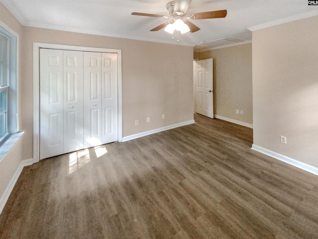 unfurnished bedroom with ornamental molding, a closet, dark hardwood / wood-style floors, and ceiling fan