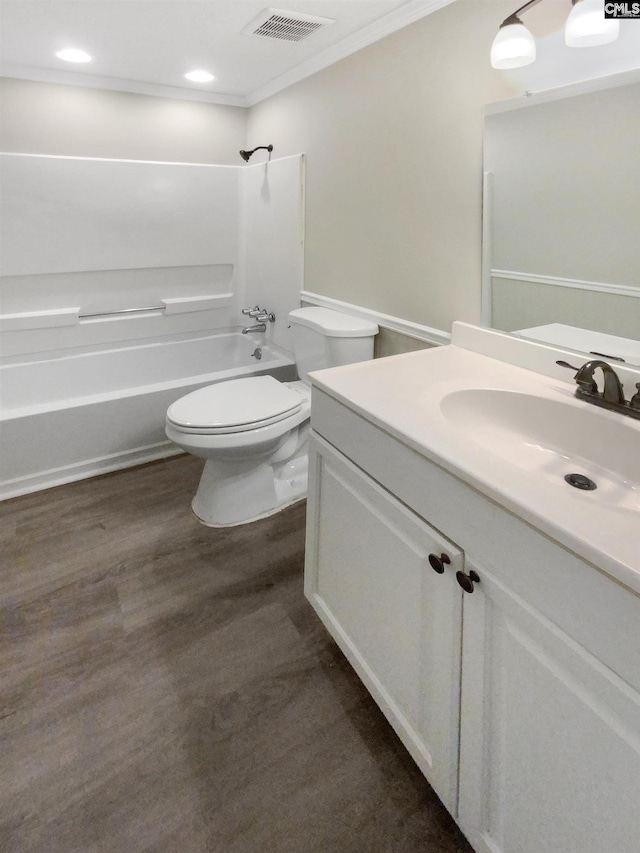 full bathroom with toilet, shower / washtub combination, hardwood / wood-style floors, ornamental molding, and vanity