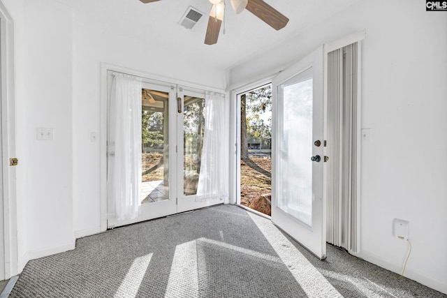 doorway featuring carpet and ceiling fan