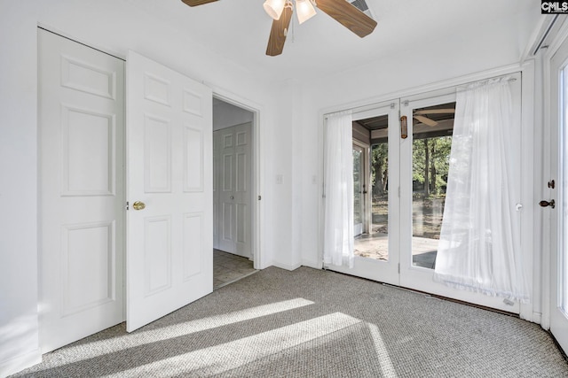 unfurnished room with ceiling fan and light colored carpet