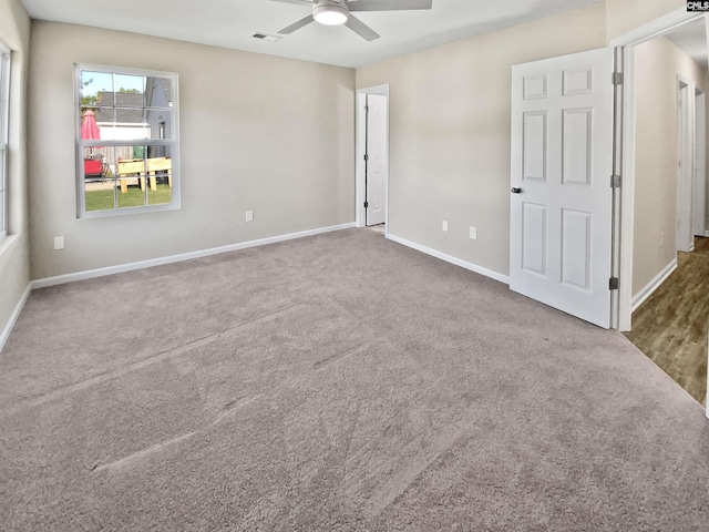 spare room with carpet floors and ceiling fan