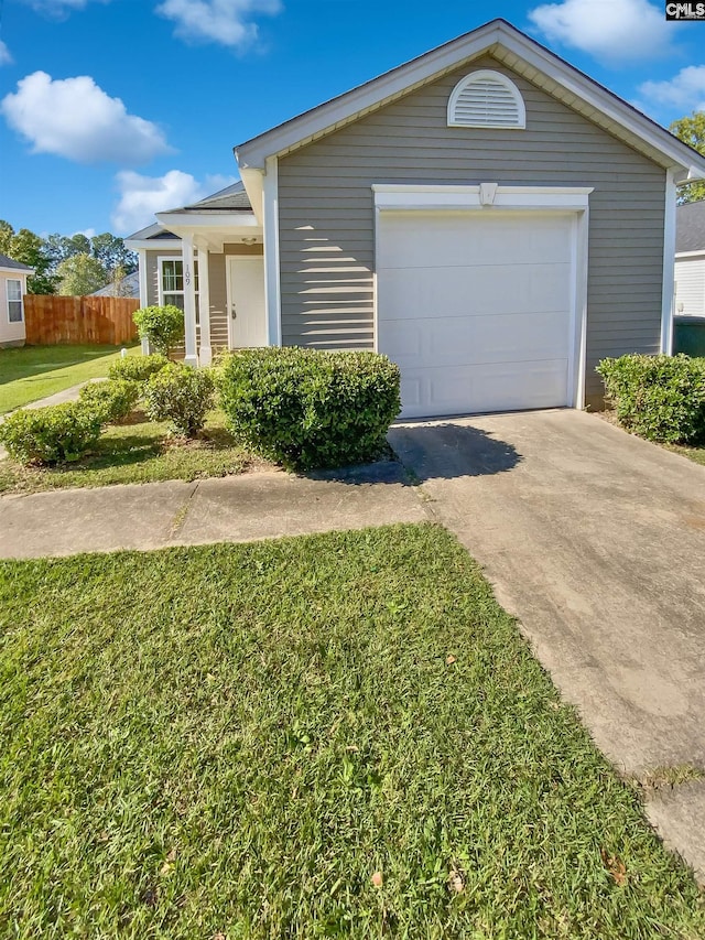 single story home featuring a front lawn and a garage