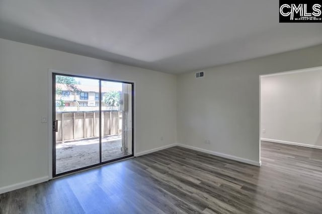 unfurnished room with dark hardwood / wood-style flooring