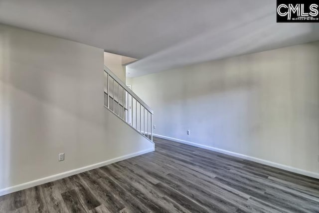 unfurnished room with dark hardwood / wood-style flooring