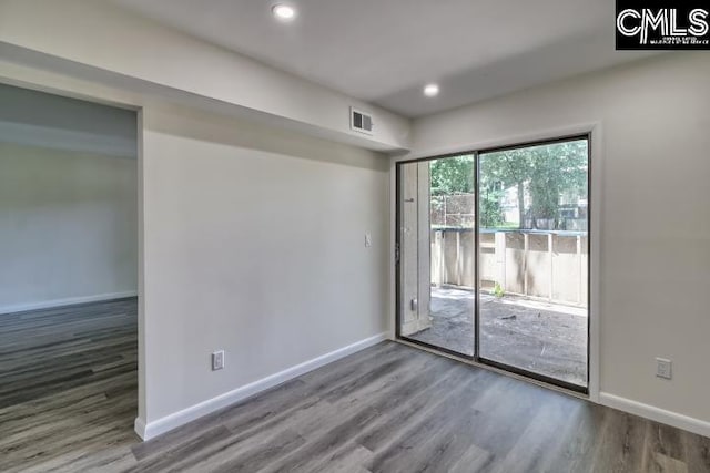 unfurnished room with hardwood / wood-style flooring