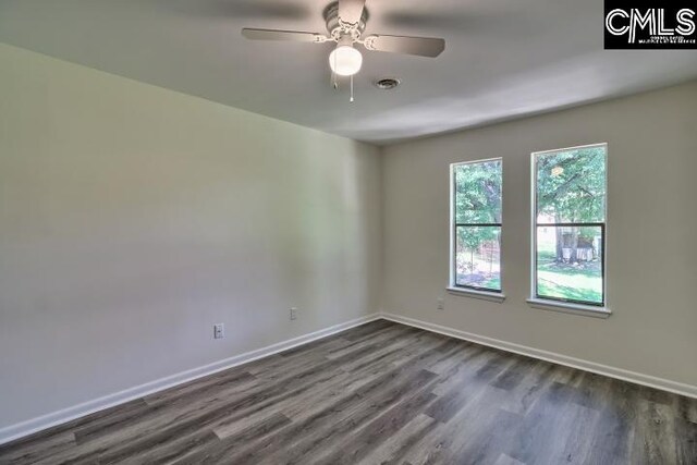 empty room with dark wood-type flooring and ceiling fan