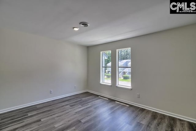 empty room with dark hardwood / wood-style floors