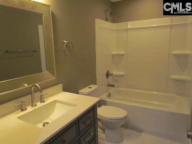 full bathroom with  shower combination, vanity, toilet, and tile patterned floors