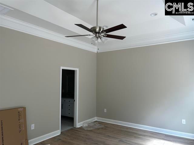 unfurnished bedroom with ceiling fan, wood-type flooring, and ornamental molding