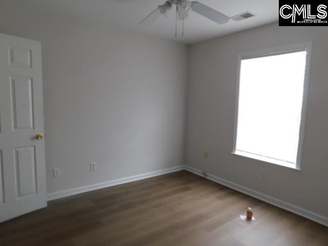 unfurnished room featuring hardwood / wood-style floors and ceiling fan