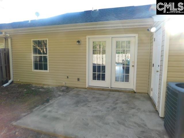 property entrance with a patio and central AC