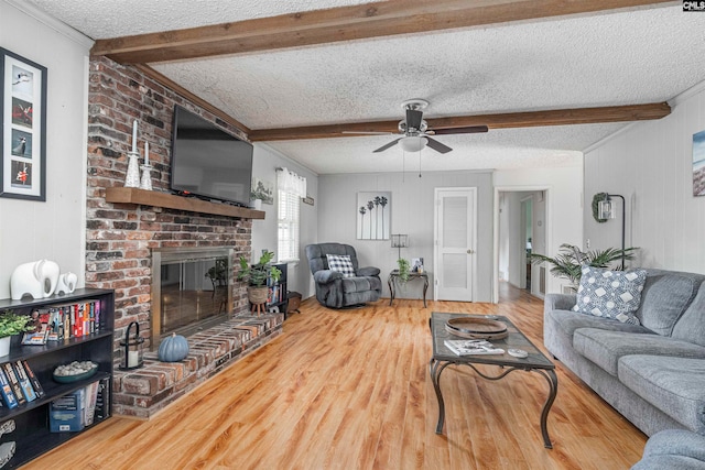 living room with hardwood / wood-style flooring, beamed ceiling, and a textured ceiling