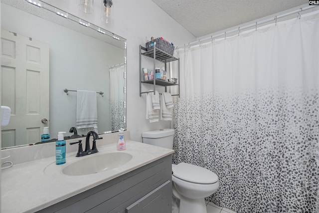 bathroom featuring a shower with curtain, tile patterned floors, a textured ceiling, toilet, and vanity