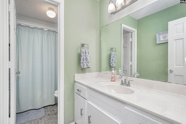 bathroom featuring walk in shower, tile patterned flooring, a textured ceiling, toilet, and vanity