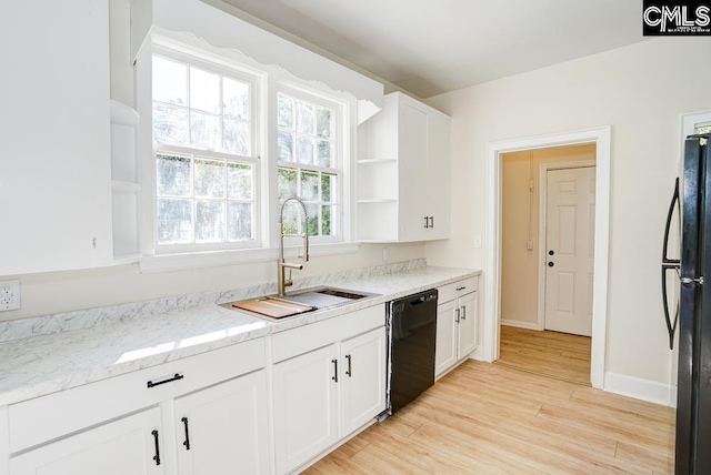 kitchen with black appliances, light hardwood / wood-style flooring, a healthy amount of sunlight, and white cabinets