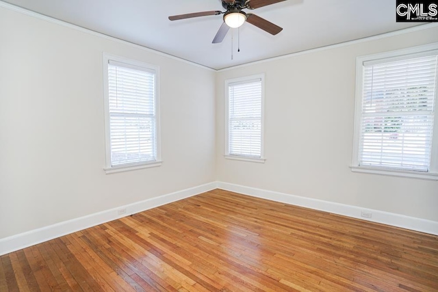 unfurnished room with crown molding, a healthy amount of sunlight, wood-type flooring, and ceiling fan