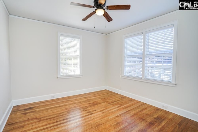 empty room with ornamental molding, wood-type flooring, and ceiling fan